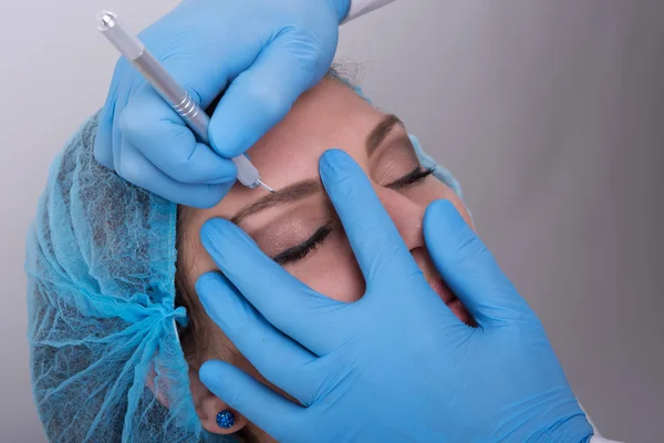 Young woman getting a permanent eyebrow make up treatment