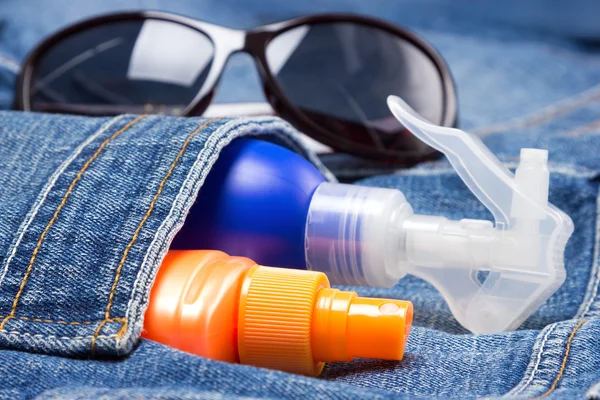 Cosmetic sunscreen products in jeans pocket