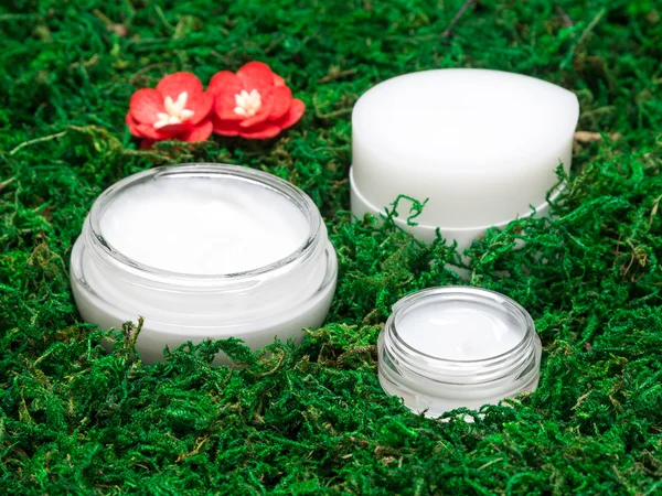 Organic skin care cosmetic products on green moss