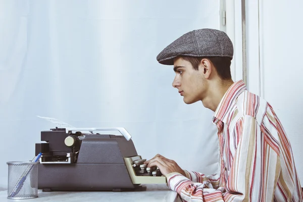 Man typing on typewriter
