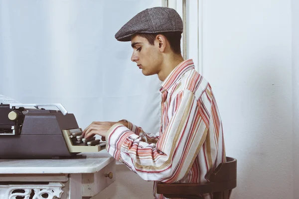 Man typing on typewriter