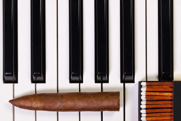 Piano keyboard and luxury cigar