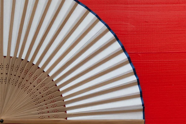 Japanese hand fan made on the red table