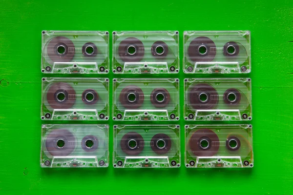 Set of old audio cassettes on wooden table.