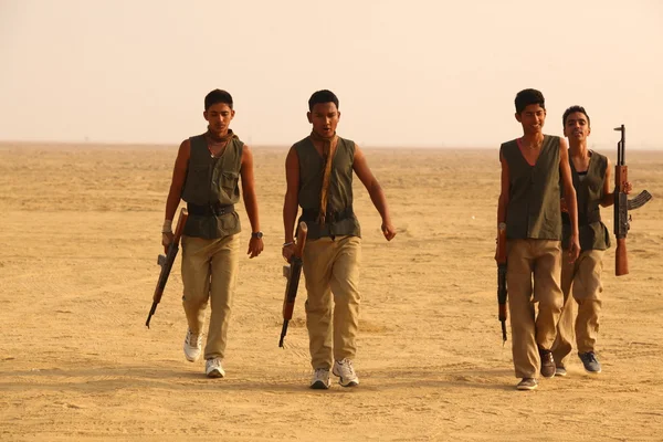 Men with guns in Desert