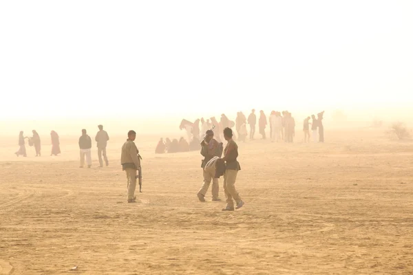 Men with guns in Desert