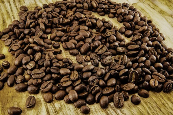 Coffee beans on vintage wooden board