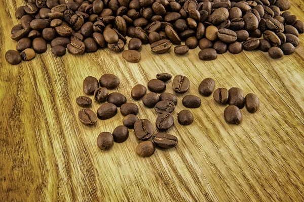 Coffee beans on vintage wooden board