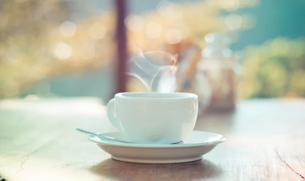 Outdoor Coffee cup with natural bokeh - vintage effect process s