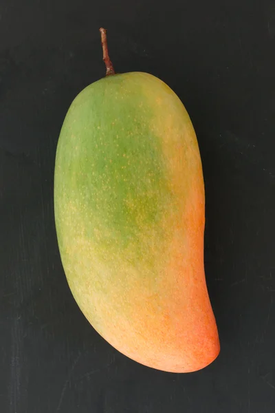 Mango fruit on black background