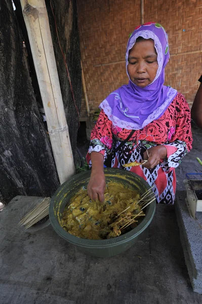 LOMBOK, INDONESIA-JUNE 10,2015: Unidentified local woman prepari