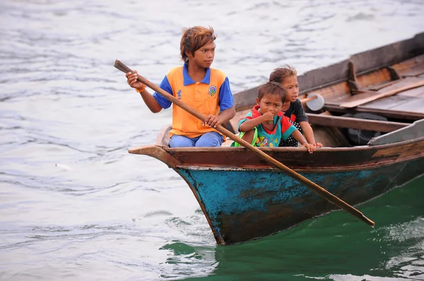 SEMPORNA, MALAYSIA- MARCH 5, 2015 : Unidentified bajau boy padel