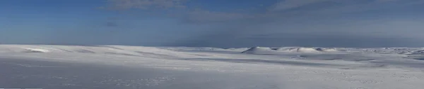 Panorama of snow-covered tundra and hills north of Bering Island
