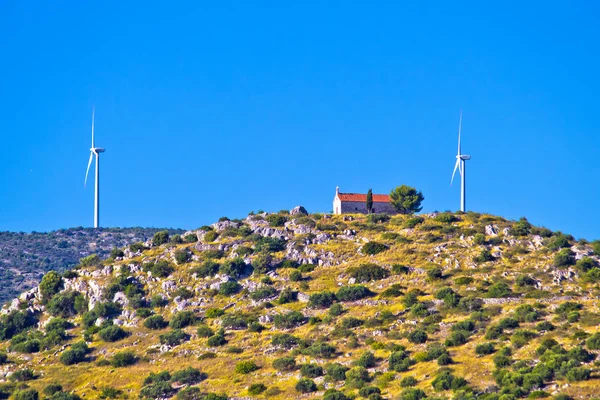 Old stone church and green energy plant