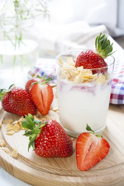 Yogurt with fresh strawberry and corn flakes