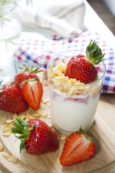 Yogurt with fresh strawberry and corn flakes