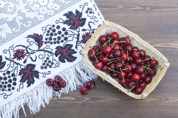 Fresh cherries on embroidered towel