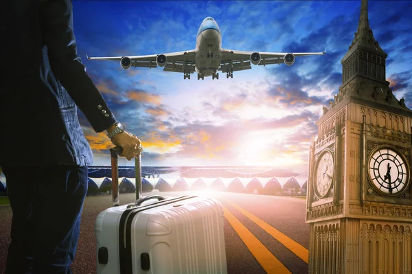 Business man and luggage standing in airport and passenger jet p