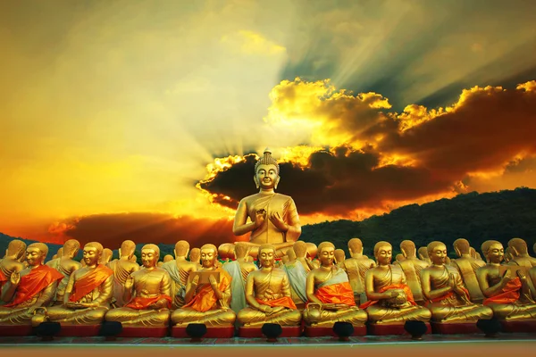 Golden buddha statue in buddhism temple thailand against dramati