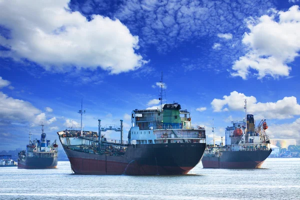 Oil and industrial tanker transport ship floating on river port