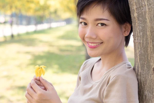 Close up face of young asian woman with smiling face and relaxin