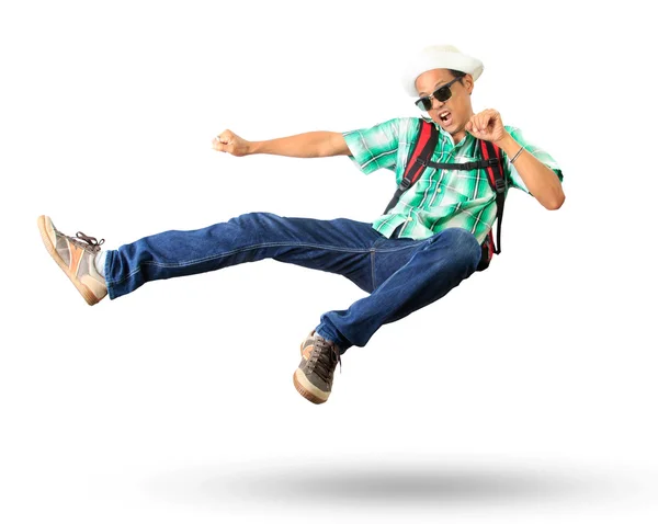 Young man with back pack sky kick jumping action isolated white