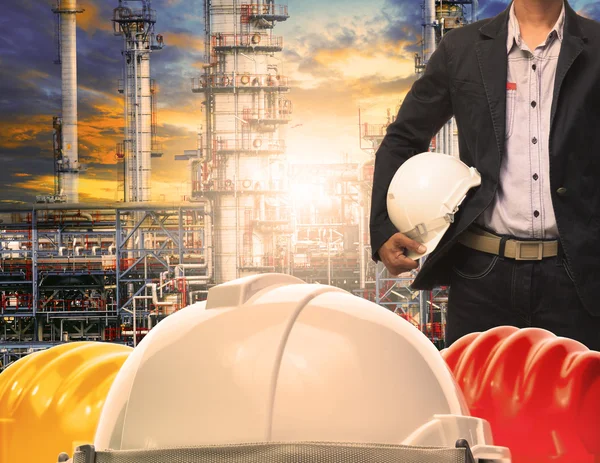 Engineering man with white safety helmet standing in front of oi