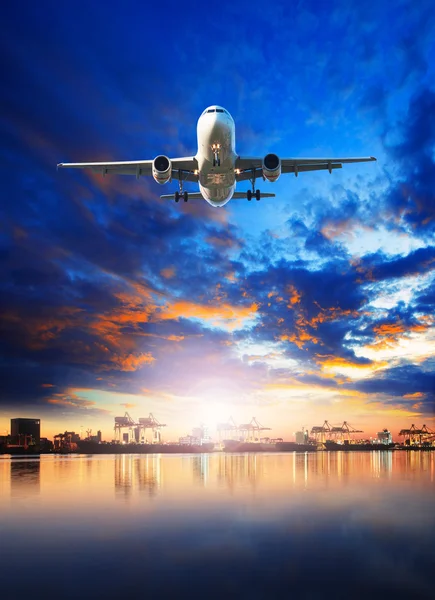 Air cargo plane flying over ship in harbor port use for freight