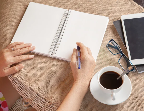 Woman writing shot memories note on white paper with relaxing ti