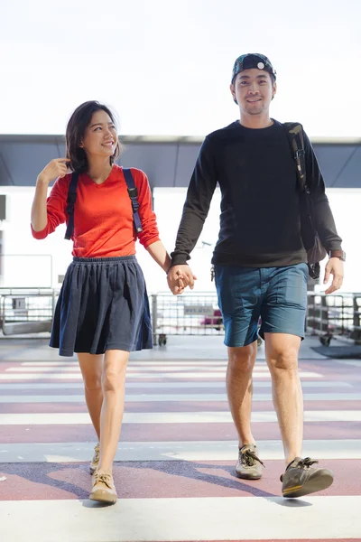 Couples asian younger man and woman hand by hand walking with ha