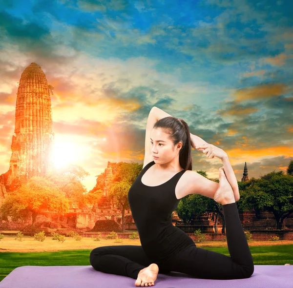 Asian woman health care yoga posting with asian ancient pagoda t