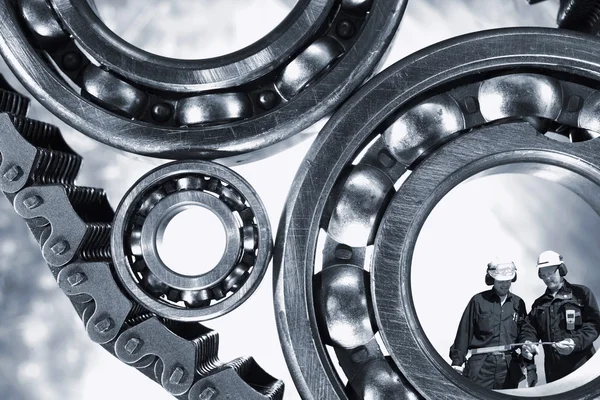 Mechanics standing inside giant ball-bearings