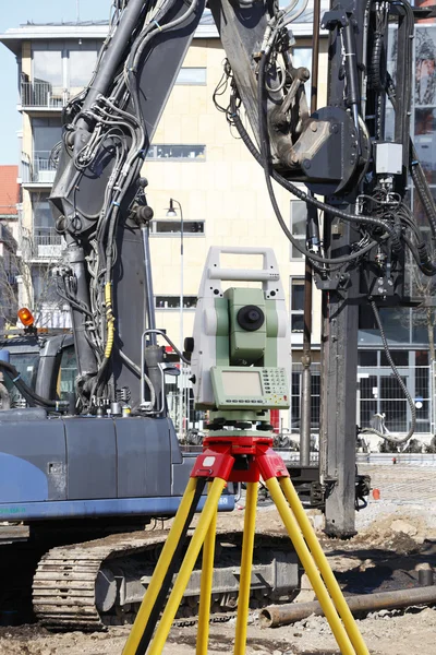 Surveying instrument and heavy construction machinery