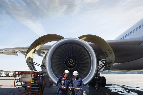 Airplane mechanics, engineers and jet engine