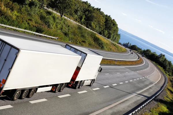 White truck driving on scenic highway