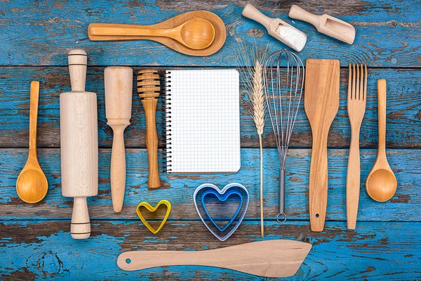 Set kitchen utensils and a notebook for recipes
