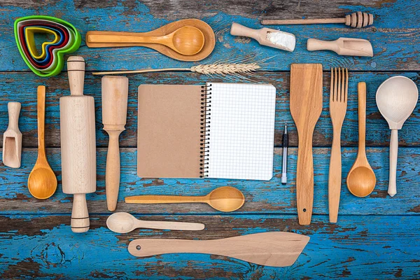 Set kitchen utensils and a notebook for recipes