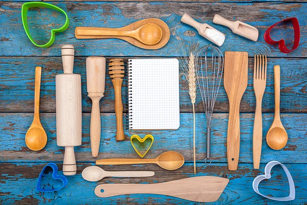 Set kitchen utensils and a notebook for recipes