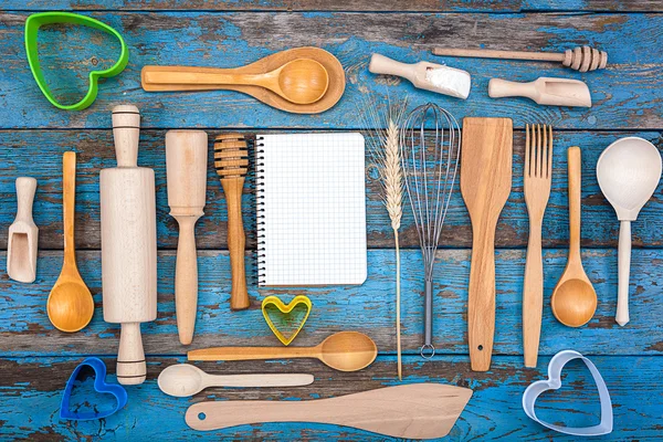 Set kitchen utensils and a notebook for recipes