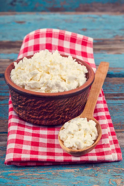 Fresh cottage cheese in a ceramic dish and spoon