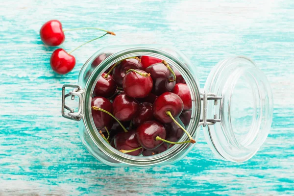 Glass bank with cherries inside