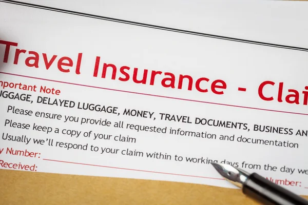 Travel Insurance Claim application form and human hand with pen