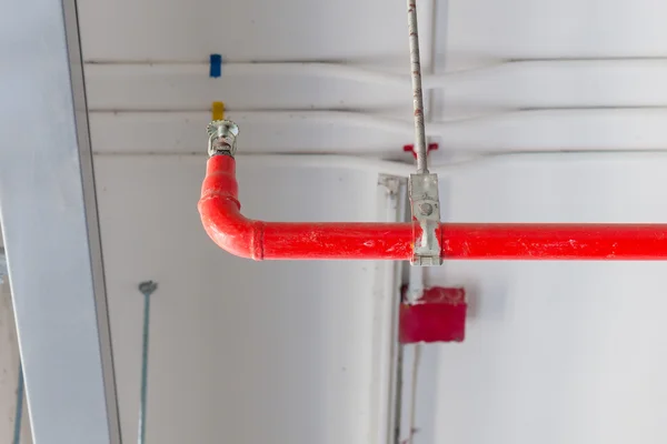 Fire sprinkler and red pipe installed on ceiling for safety conc