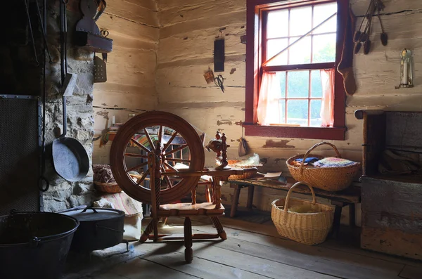 Interior of an old country house with antique spinning wheel