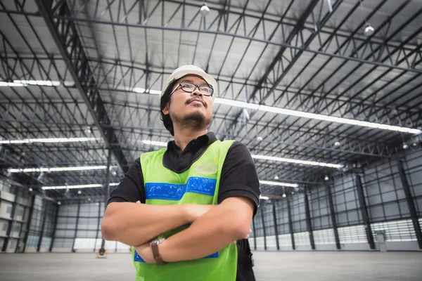 Engineer working and standing in new warehouse