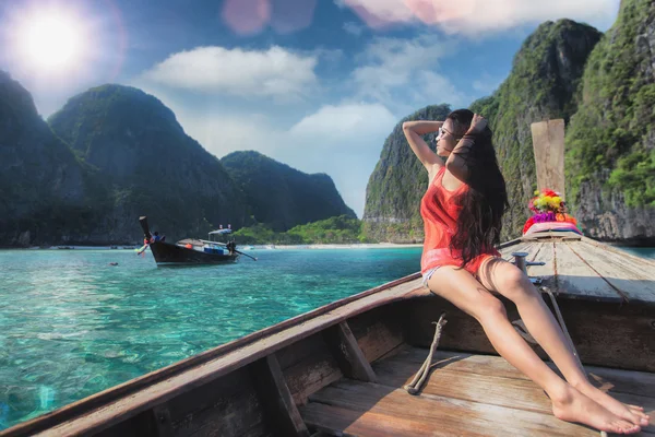 Asian lady relax on long tail boat at maya beach