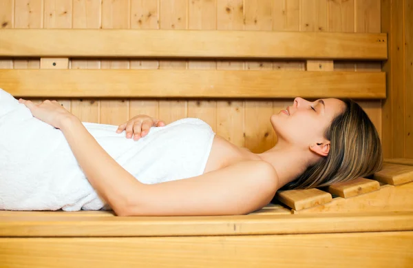 Woman relaxing in sauna