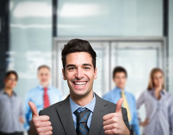 Businessman showing thumbs up