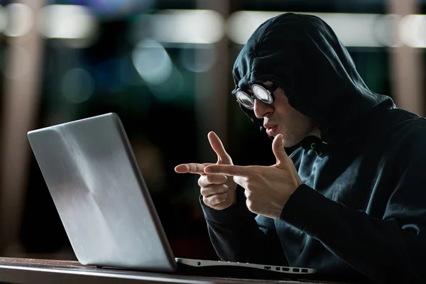 Hacker in front of notebook