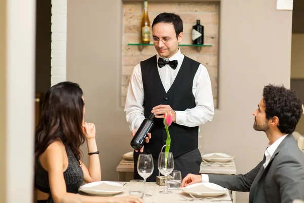 Customers choosing bottle in restaurant